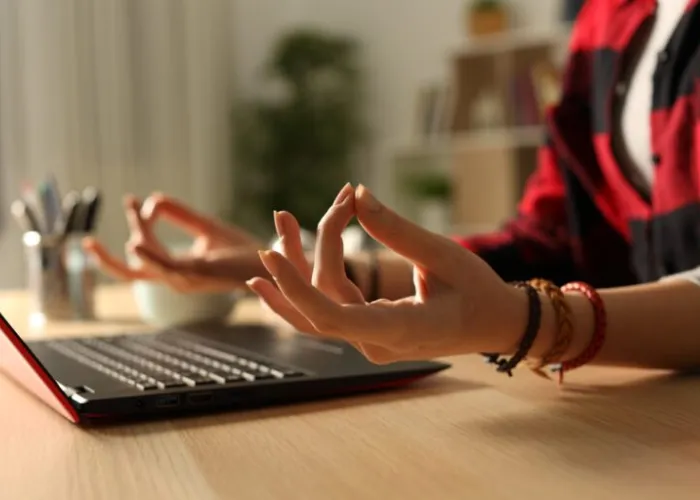 Woman's hands in front of a computer