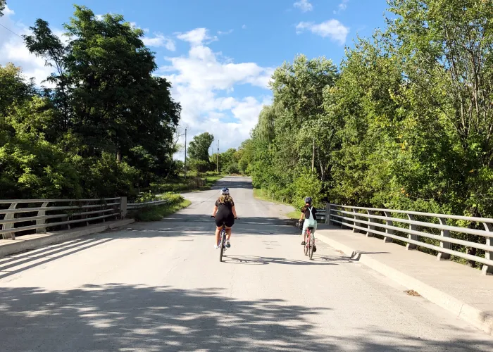 Cyclers in Hastings County crossing over a picturesque bridge