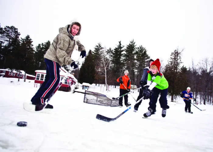 People playing Ice Hockey on a pond or lake
