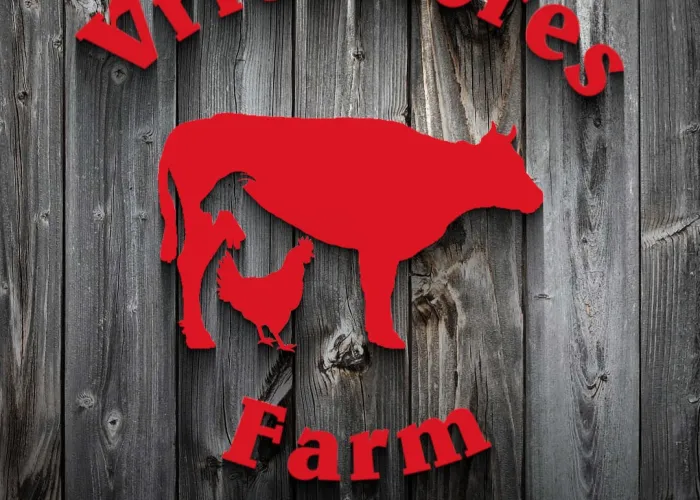 Vries Acres Logo. Red writing on a black wood background. Image includes silhouette  of a cow, goat and chicken. 