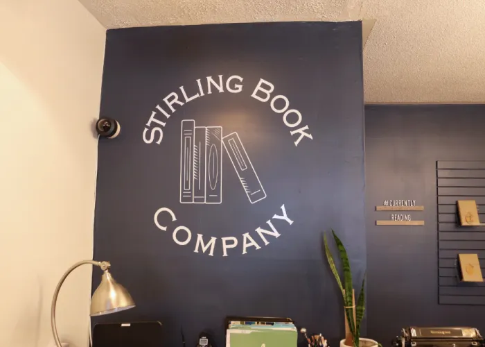 Stirling Book Company logo in white on a blue wall. 