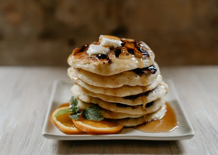 pancakes on a plate with maple syrup
