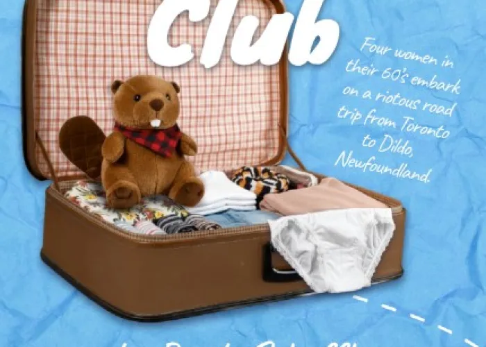 A beaver stuffed animal sitting inside an open suitcase filled with clothes