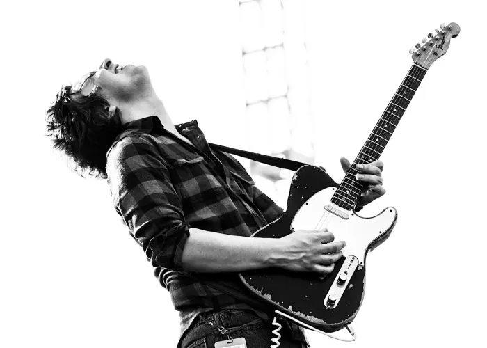 Black and white photo of Davy Knowles playing guitar