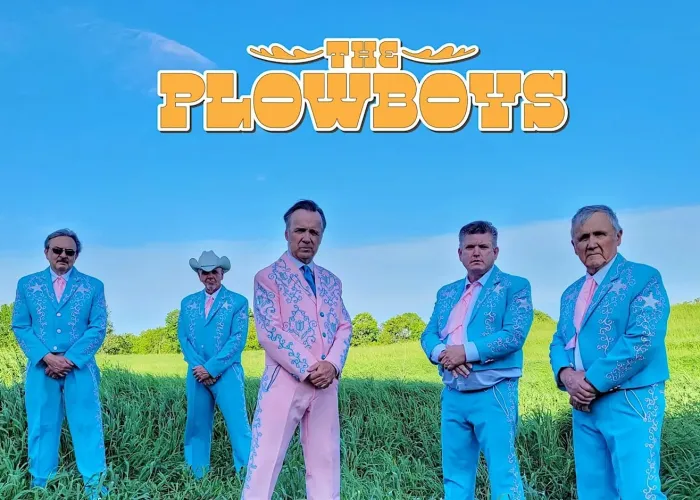 Four members of the plowboys in blue suits one member in a pink suit in a green field with blue skies above