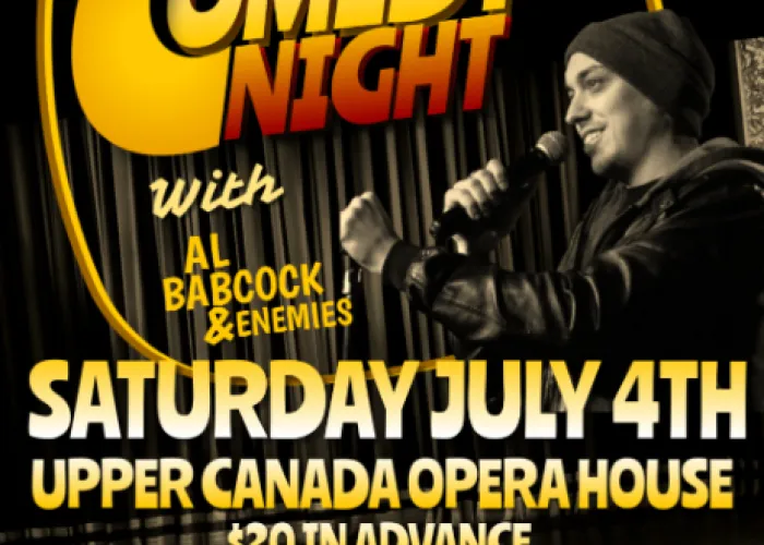 Al Babcock on stage holding microphone, event details