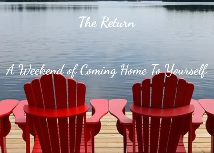Four red Muskoka chairs on a dock facing a lake