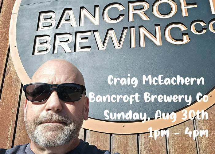 Craig McEachern in sunglasses in front of Bancroft Brewing Co. sign, event details in white writing