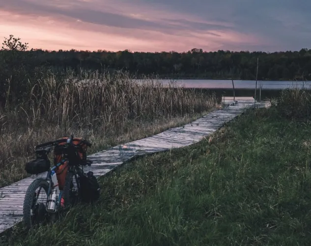 Bikepacking Bicycle parked at a dock overlooking the lake at Sunset in Hastings County, Ontario